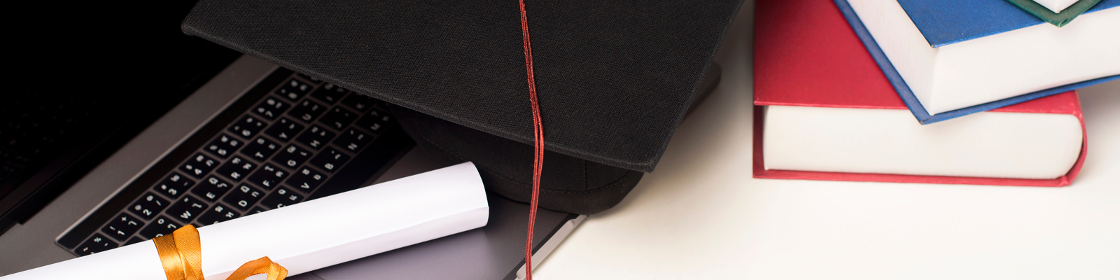Graduation cap with laptop computer, online education concept